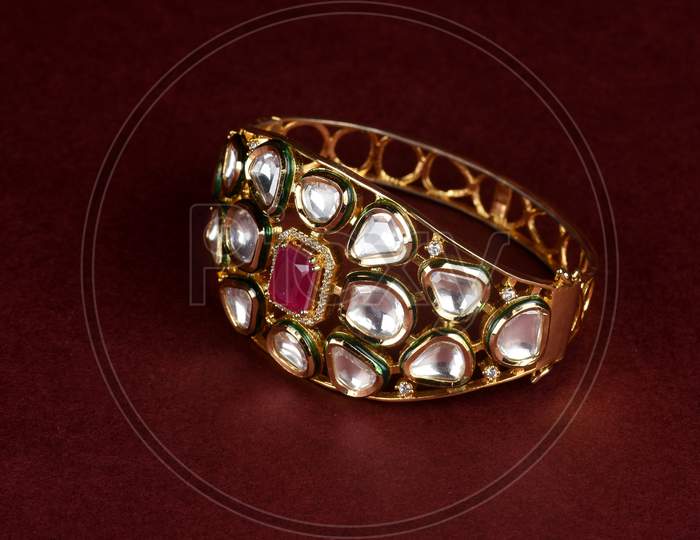 Gold Bracelet On Red Background,Kundan Bracelet,Style, Fashion And Design Of Jewelry. Indian Traditional Jewellery,Indian Wedding Jewellery