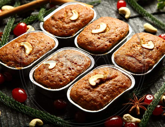 Christmas cup cakes on a holidays background.