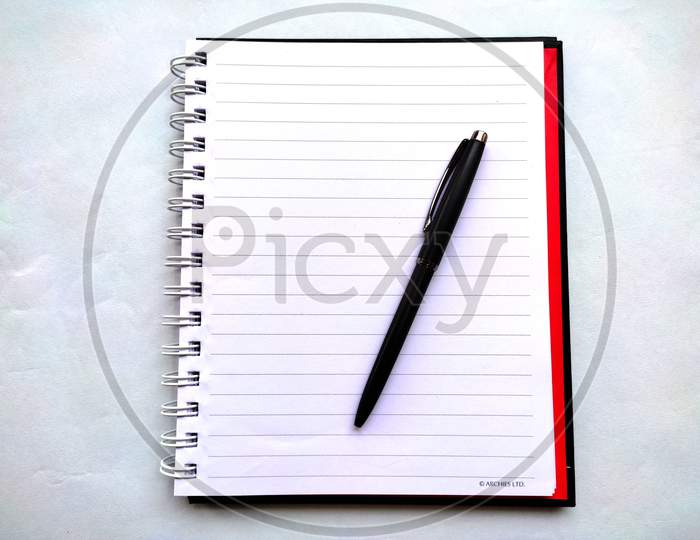 Spiral Notebook with Black Pen isolated on white background