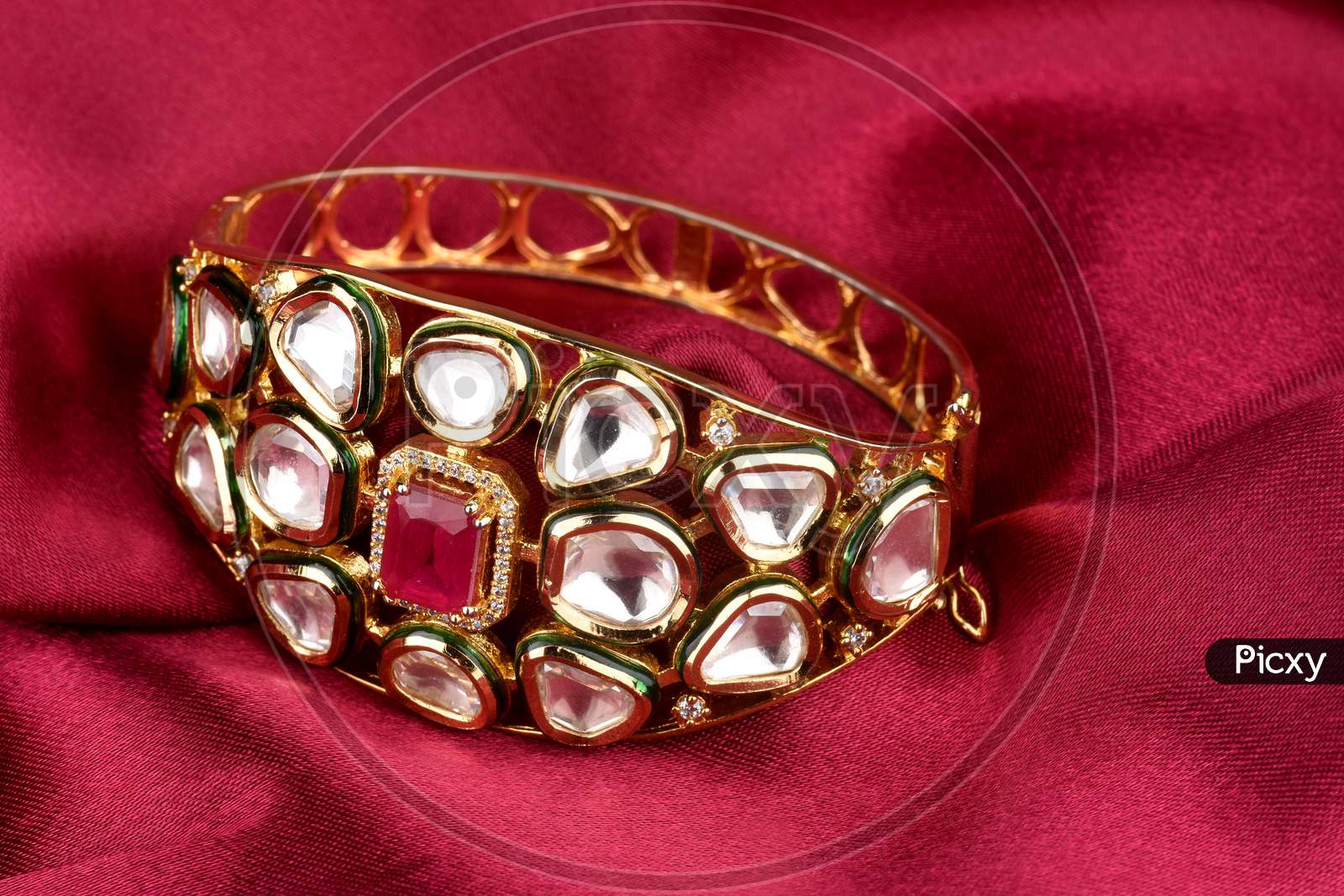 Gold Bracelet On  A Red Satin Background. Kundan Bracelet,Style, Fashion And Design Of Jewelry. Indian Traditional Jewellery,Indian Wedding Jewellery
