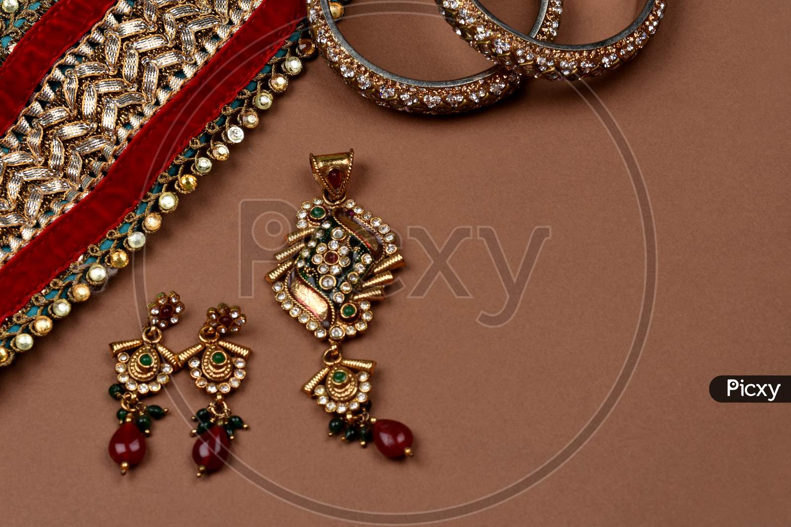 Antique Jewellery On A Brown Background, Golden Scarf, Gold Bracelet,Jewelry Background, Gold Necklace, Gold Earrings, Finger Ring.Style, Fashion And Design Of Jewelry. Indian Traditional Jewellery