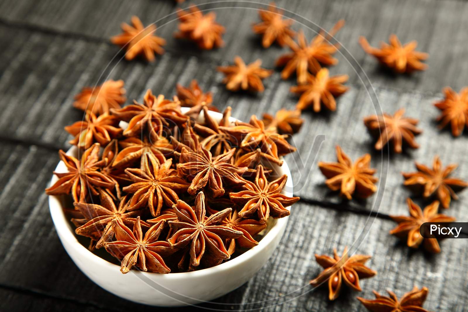 Aromatic star anise in bowl.