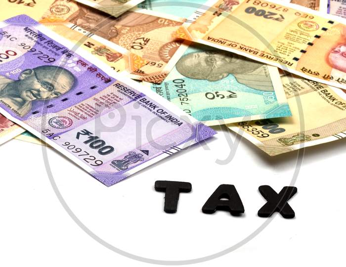 Tax Concept,Tax Alphabet On Money Background,Business And Financial Concept Idea,Indian Currency, Rupee, Indian Rupee,Indian Money, Business, Finance, Investment, Saving And Corruption  - Image