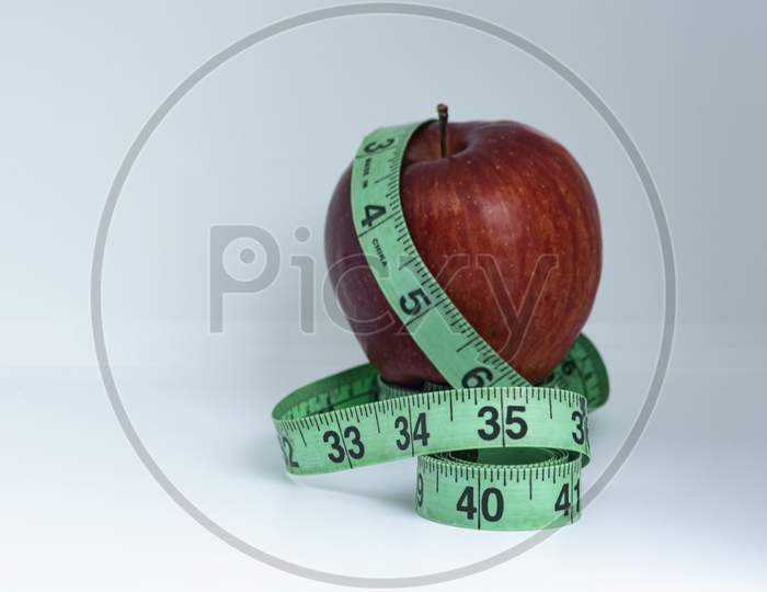 Blurred Red Apple With Measuring Tape Isolated On White