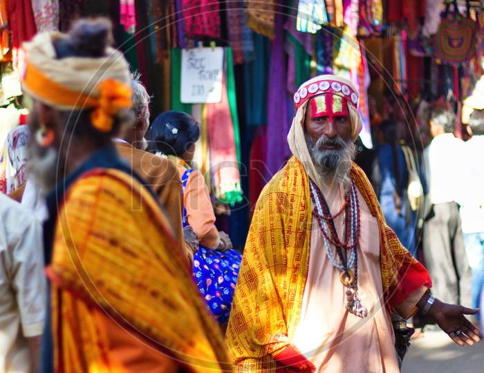 Pushkar, India - November 10, 2016: A Bearded Hindu Old Man With Vishnu Tilak On His Forehead And Orange Ethnic Wear Walking In Famous Pushkar Mela Or Fair In The State Of Rajasthan