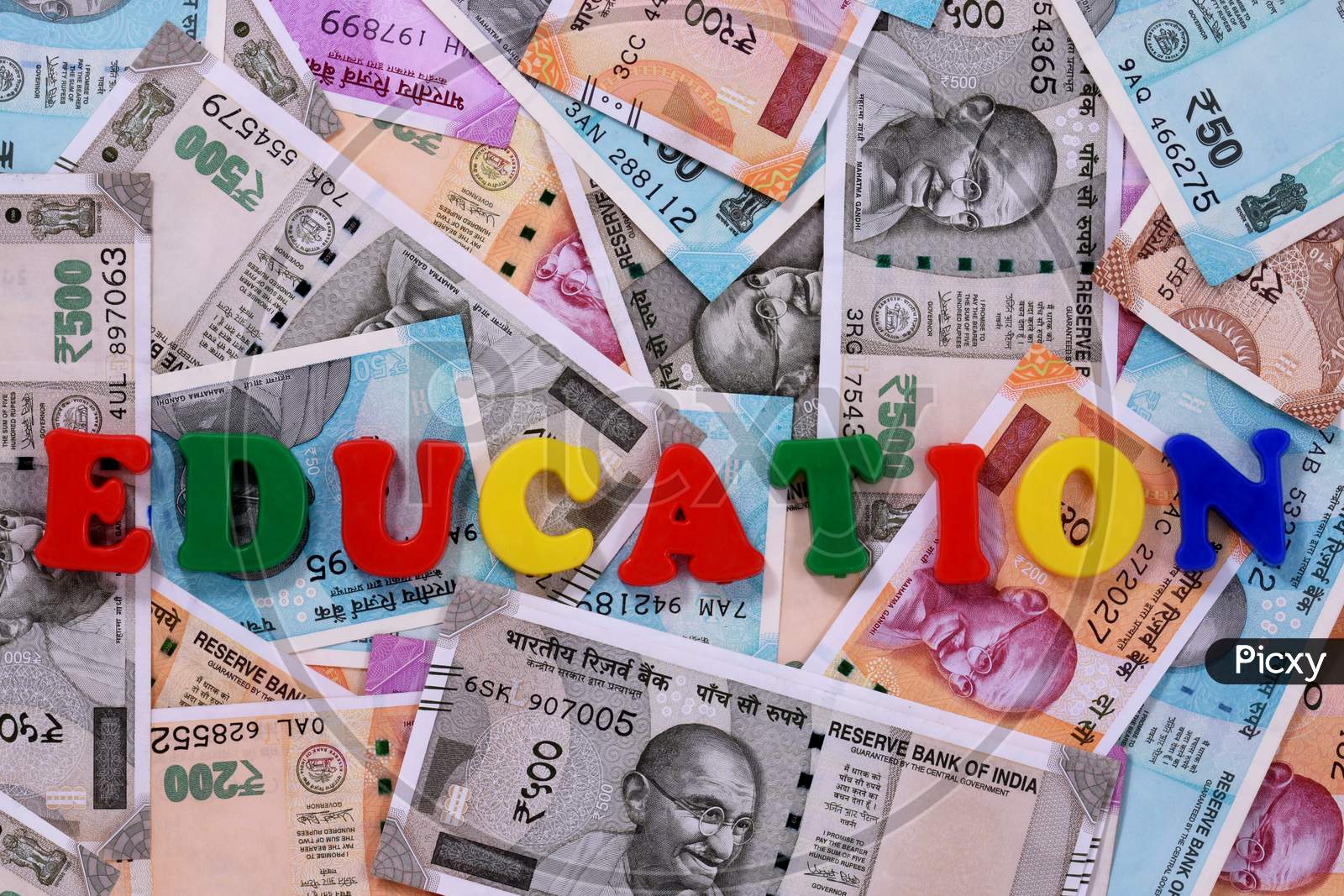 Education Concept,Education Alphabet On Money Background,Indian Currency, Rupee, Indian Rupee,Indian Money, Business, Finance, Investment, Saving And Corruption Concept - Image