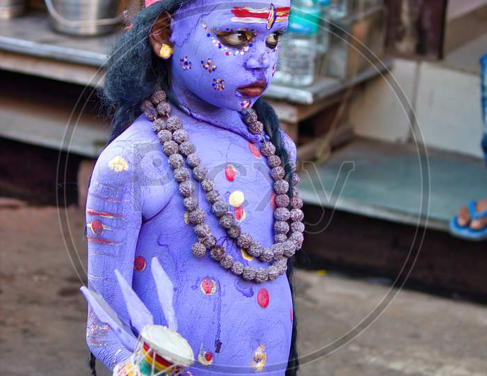 Pushkar, India - November 10, 2016: An Unidentified Boy Dressed And Disguised As Hindu Lord Shiva With Blue Paint Attends The Pushkar Cattle Fair In The State Of Rajasthan