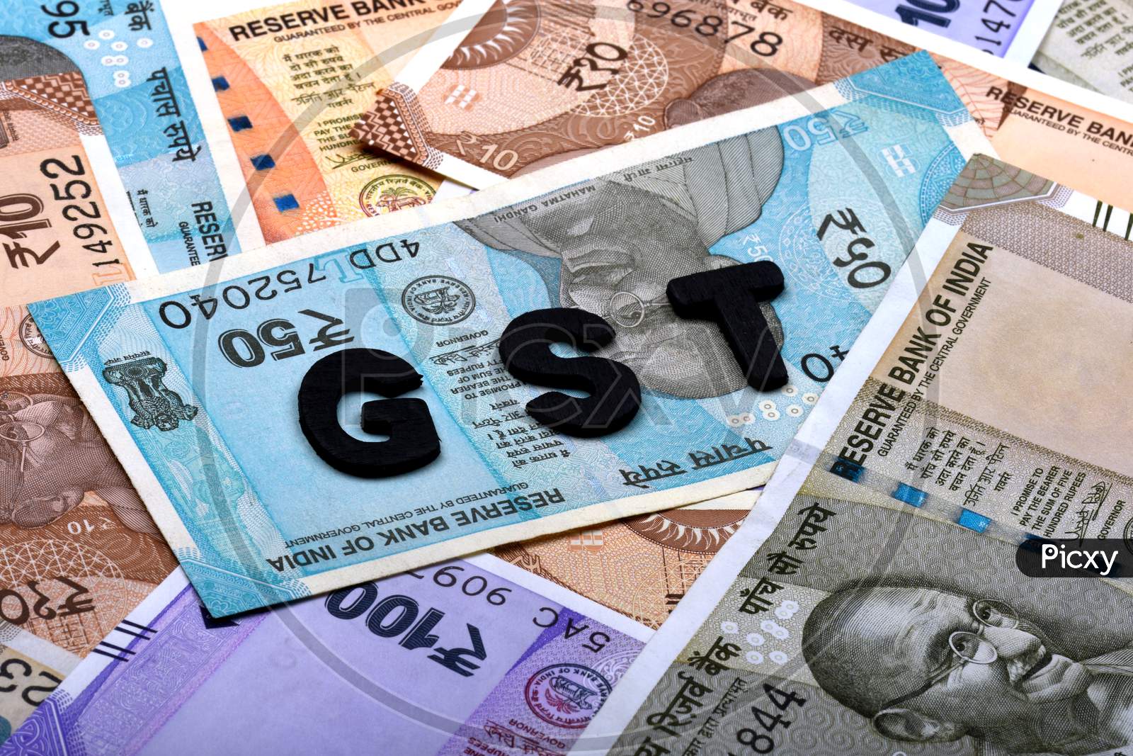 Gst Concept,Gst Alphabet On Money Background,Business And Financial Concept Idea,Indian Currency, Rupee, Indian Rupee,Indian Money, Business, Finance, Investment, Saving And Corruption - Image