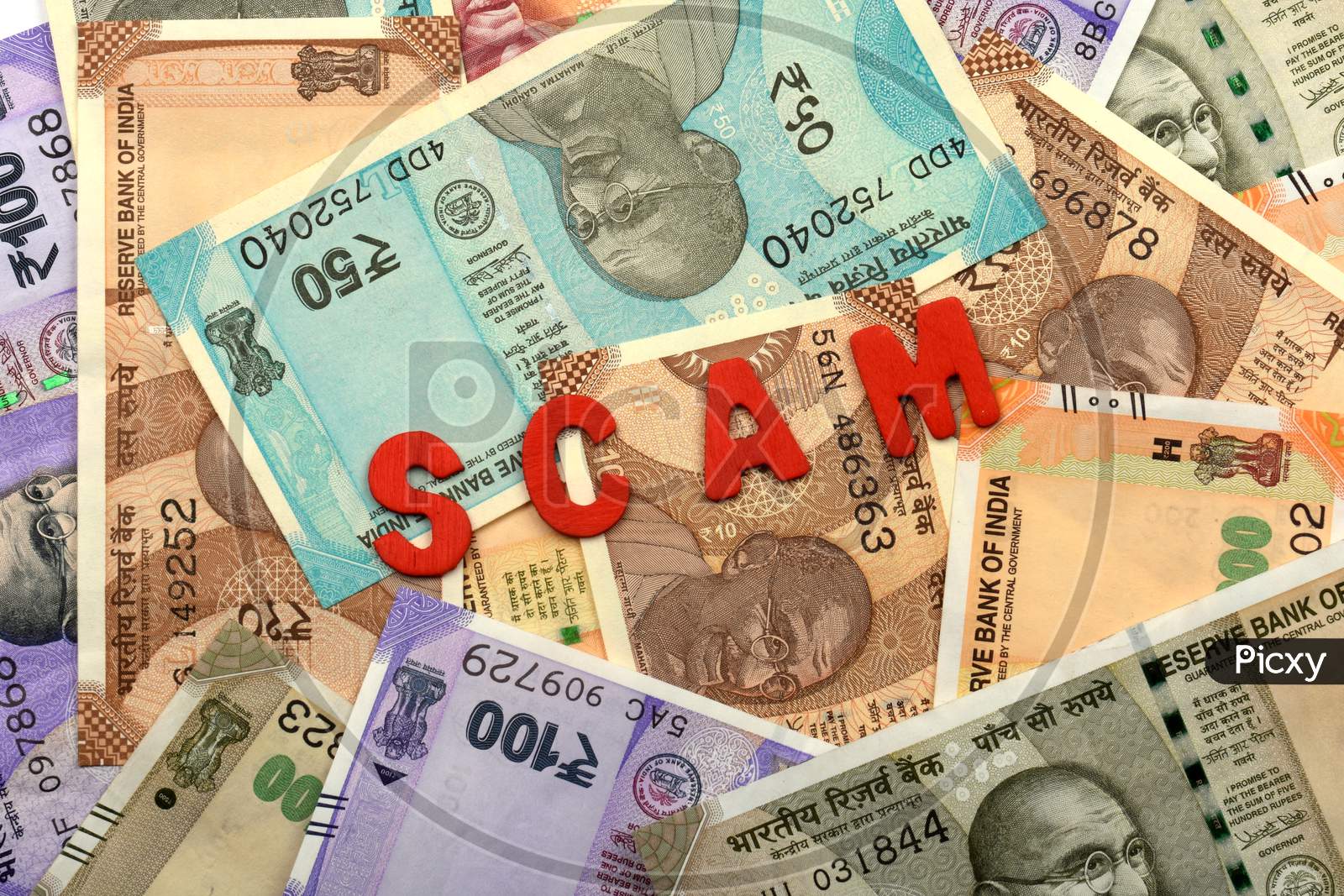 Scam And Money Concept,Scam Red Alphabets On Money Background,Indian Currency, Rupee, Indian Rupee,Indian Money, Business, Finance, Investment, Saving And Corruption Concept