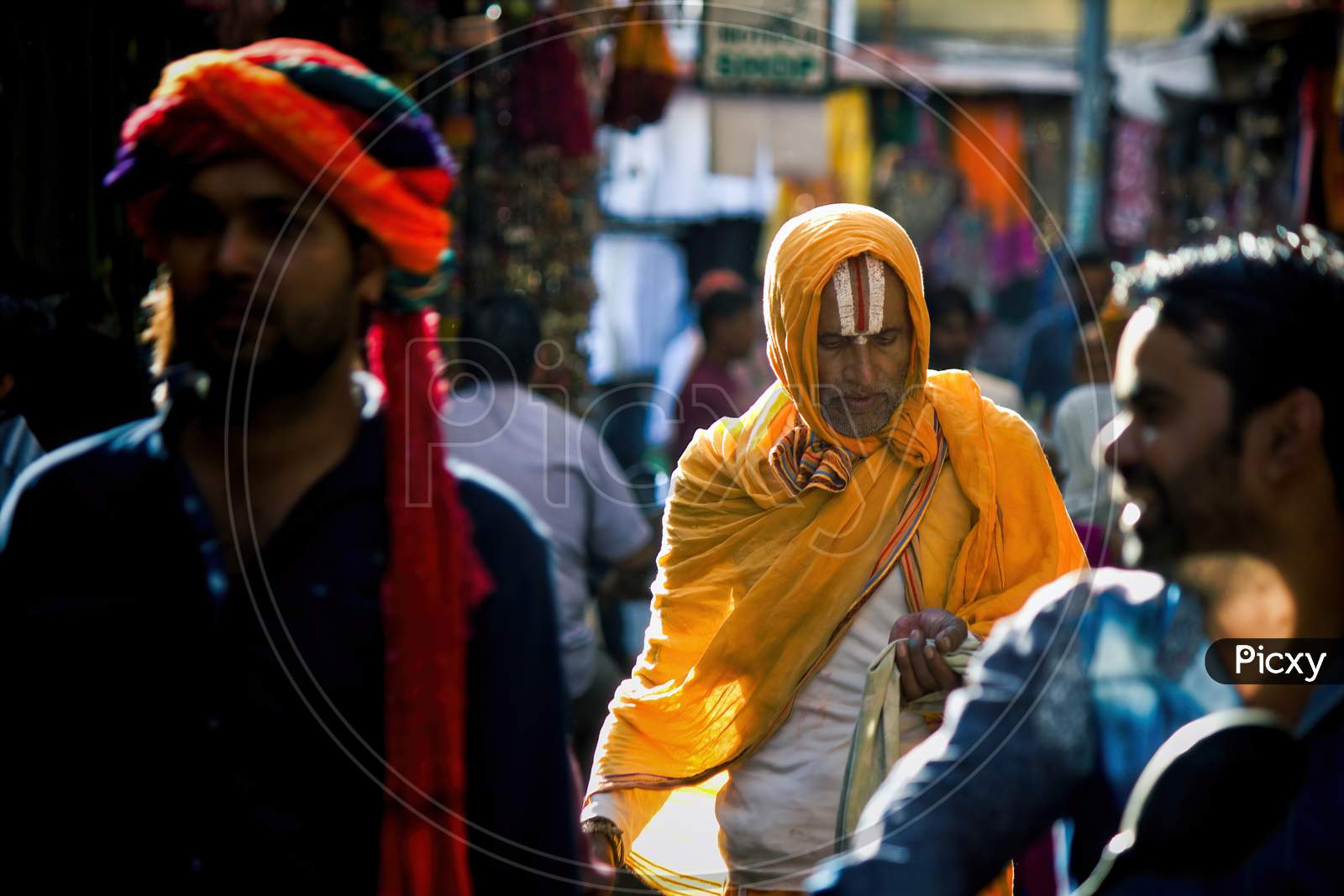 Pushkar, India - November 10, 2016: A Hindu Man With Vishnu Tilak On His Forehead And Orange Ethnic Wear Walking In Famous Pushkar Mela Or Fair In The State Of Rajasthan