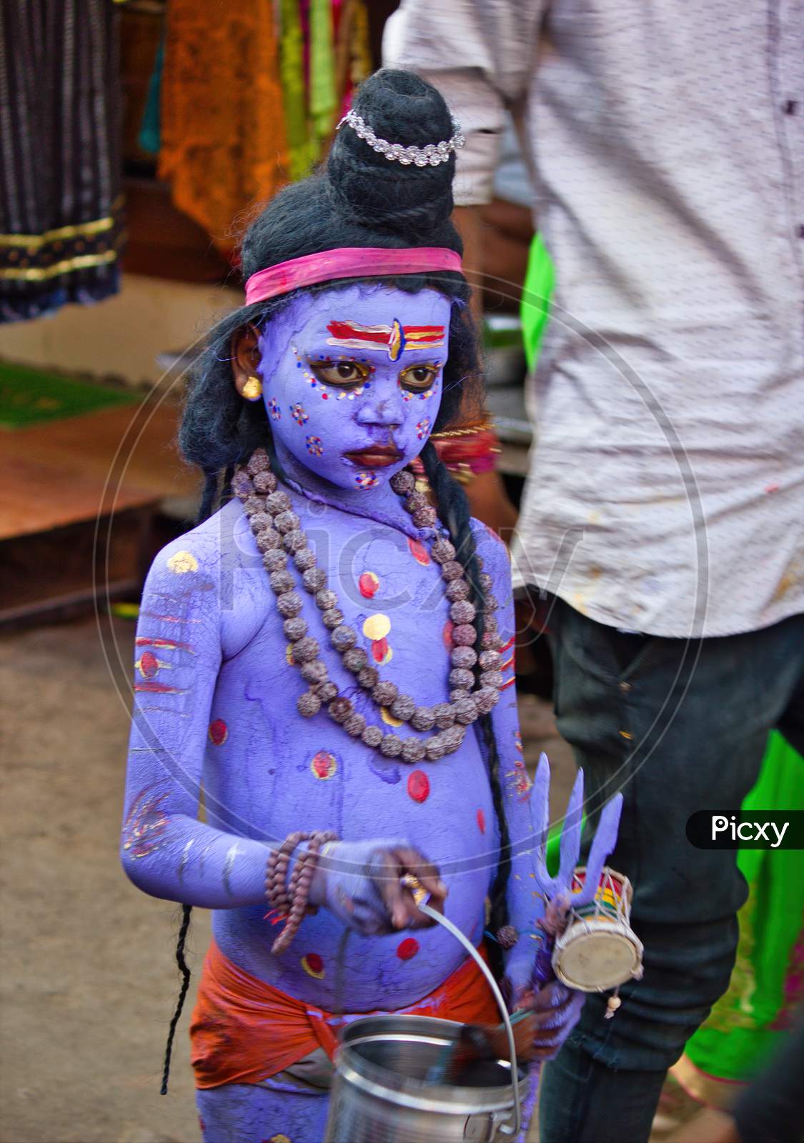 Pushkar, India - November 10, 2016: An Unidentified Boy Dressed And Disguised As Hindu Lord Shiva With Blue Paint Attends The Pushkar Cattle Fair In The State Of Rajasthan