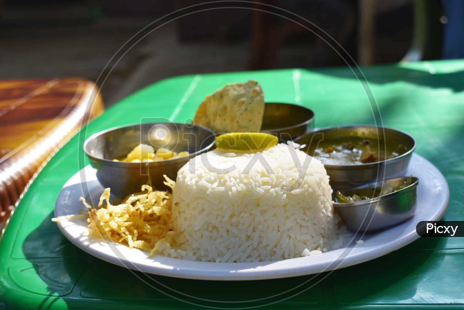 Bengali Food Thali With Rice Chips And Vegetables