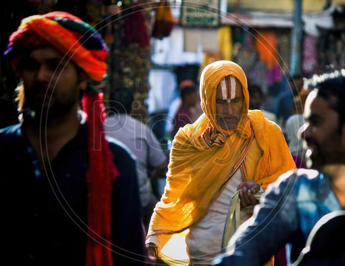 Pushkar, India - November 10, 2016: A Hindu Man With Vishnu Tilak On His Forehead And Orange Ethnic Wear Walking In Famous Pushkar Mela Or Fair In The State Of Rajasthan