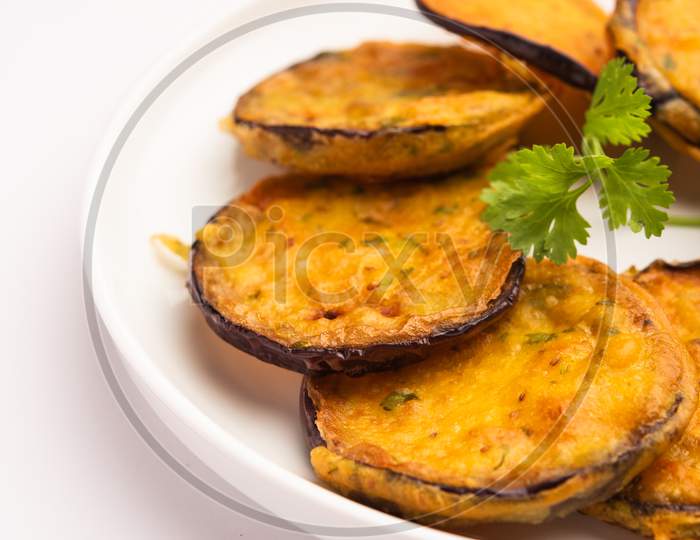 Tasty Brinjal Pakora Or Crispy Eggplant Fritters, Indian Tea Time Snack Served With Green Chutney