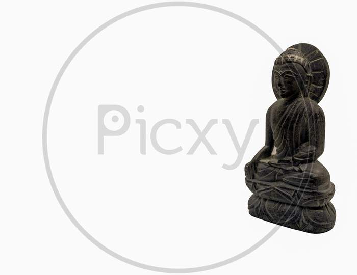 Little Stone Buddha Statue In A Sitting Meditation Posture On White Underground For Copy Paste Text.