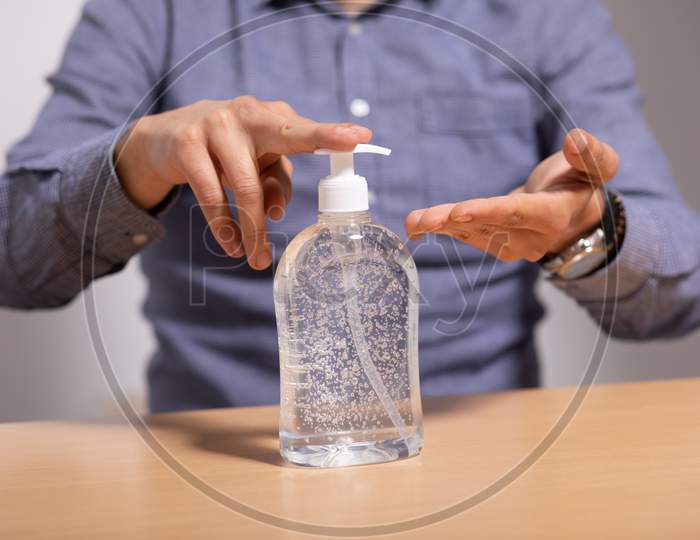 Man Applying Disinfectant Alcohol Gel On Hands