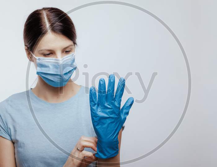 Nurse With Face Mask Wear And Checking Protective Gloves