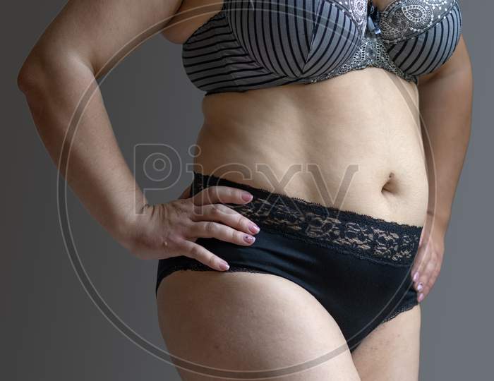 Image of Natural Real Body Plus Size Woman In Lingerie Touching Stomach -XA852282-Picxy