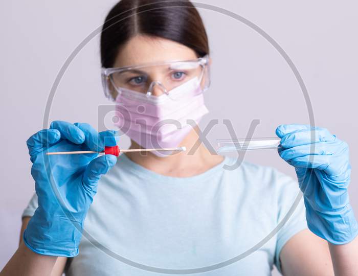 Doctor Holding Test Kit For Pcr Testing Virus Covid19. Coronavirus Covid-19 Swab Test Kit, Ppe Protective Mask And Gloves, Tube For Taking Op Np Patient Specimen Sample, Dna Rna Protocol Process