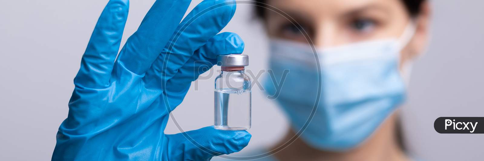 Doctor Scientist With Protective Gloves And Face Mask Holding Vaccine Medicine Dose