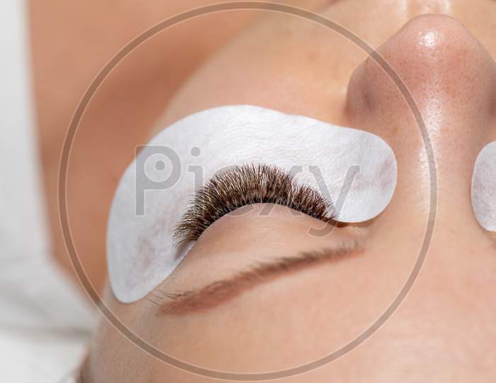 One Woman Eyes With Eyelashes Extension With Eyepatch Under Eye After Beauty Treatment