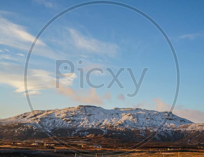 Winter Snowy Mountain And Blue Sky In Iceland