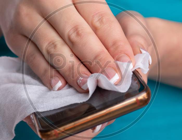 Woman'S Hands Cleaning Smartphone Mobile Phone With Wet Wipes
