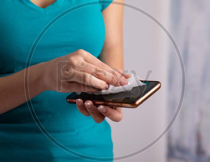 Woman'S Hands Cleaning Smartphone Mobile Phone With Wet Wipes