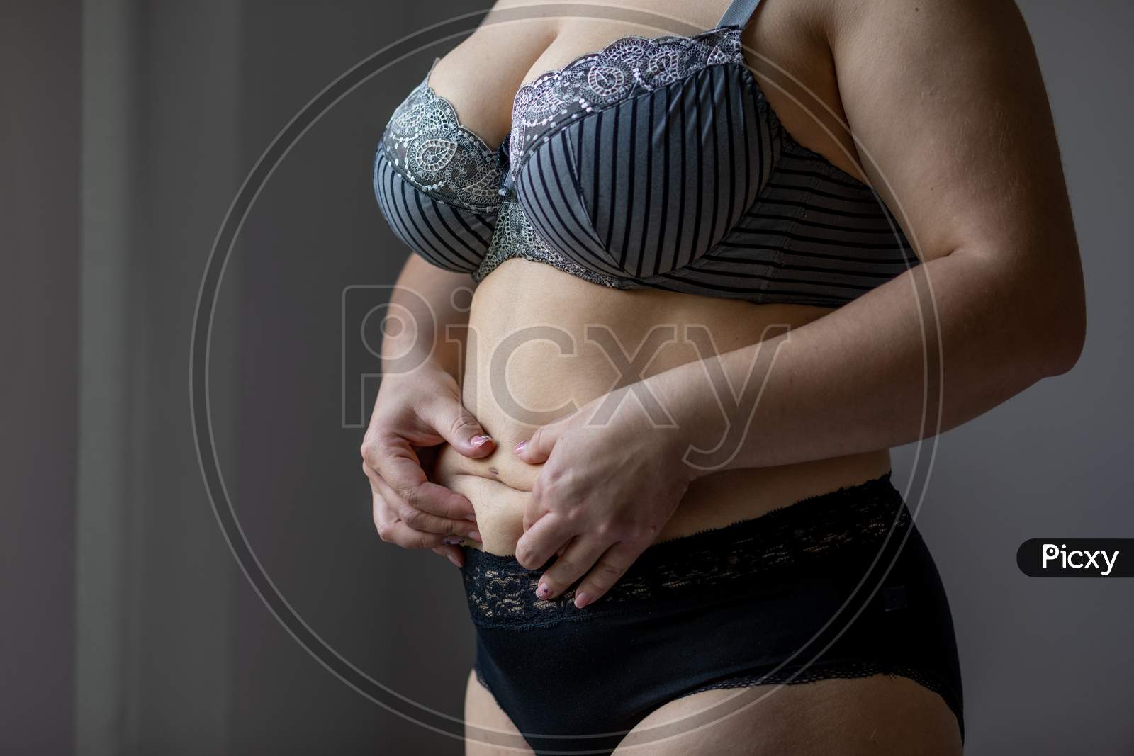 Image of Natural Real Body Plus Size Woman In Lingerie Touching  Stomach-XA852282-Picxy