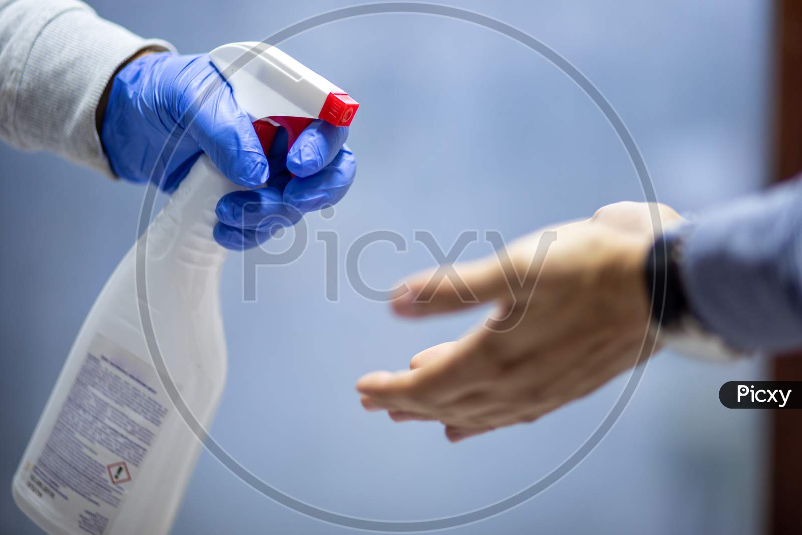 Spraying Hands With Antiseptic Solution