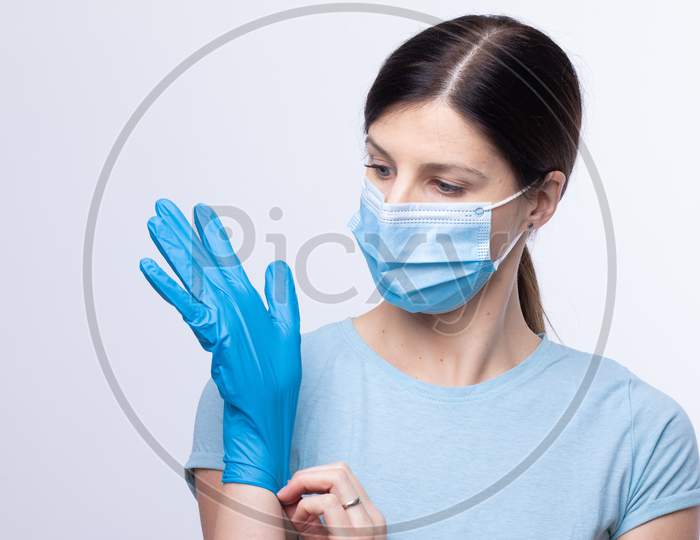 Nurse With Face Mask Wear And Checking Protective Gloves
