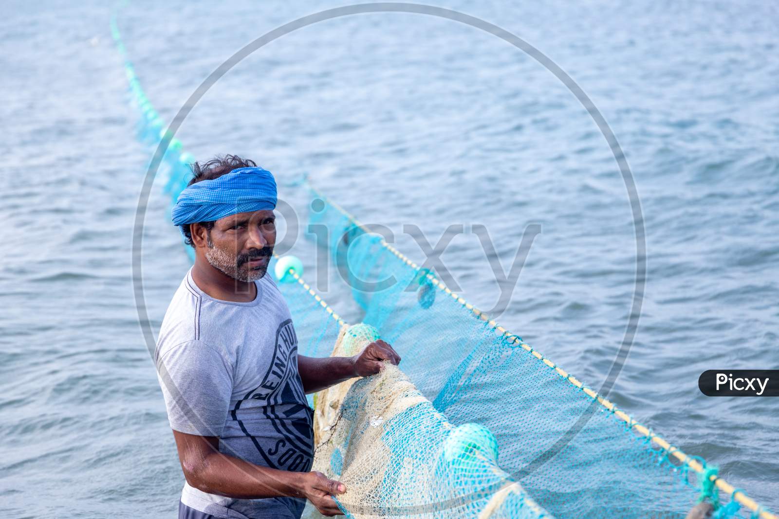 Image of Chennai, Tamil Nadu, India - Rameswaram 19 01 2021: Photo Of Man  Catching Fish With Fishing Nets-IA290787-Picxy