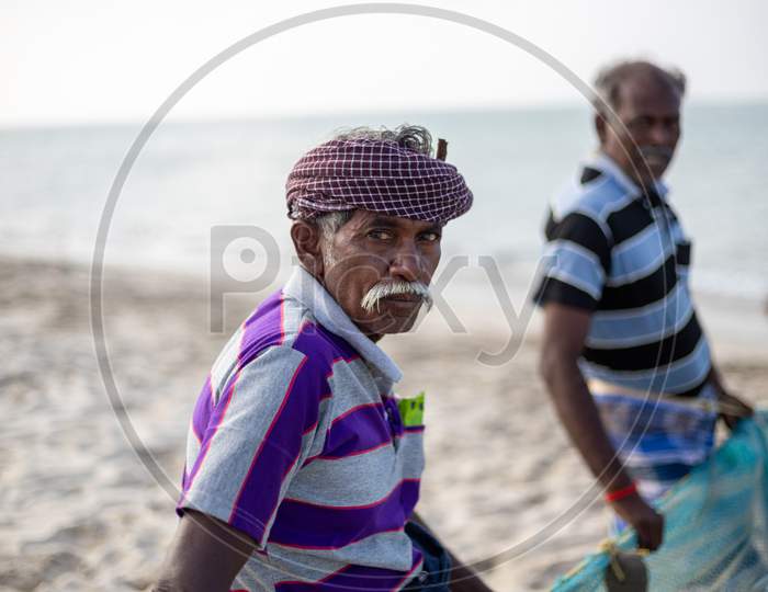 Chennai, Tamil Nadu, India - Rameswaram 19 01 2021: An Old Man With Striped T-Shirt Wearing Turban On His Head While Fishing