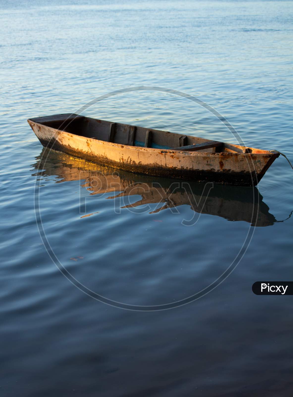 Image of Small Wooden Fisherman Boat Or Transport Moored In The Harbor. Wooden  Boat In Calm Water.-PH050030-Picxy