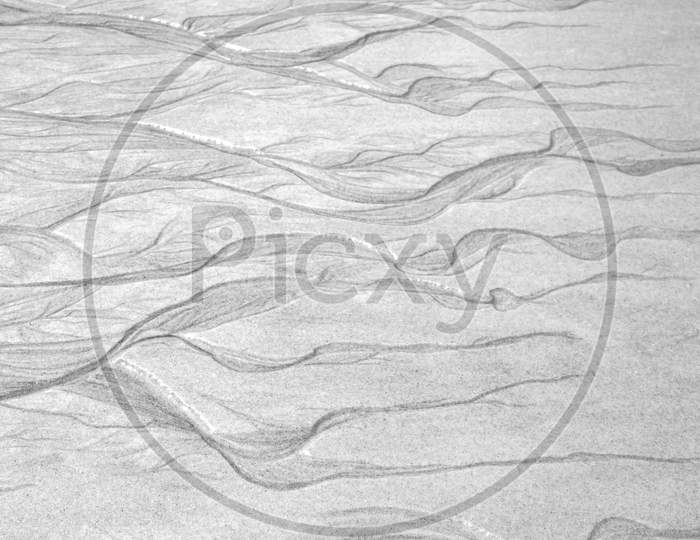 Abstract Line Patterns Formed By Sand And Water. Concept Of Loneliness And Coldness.