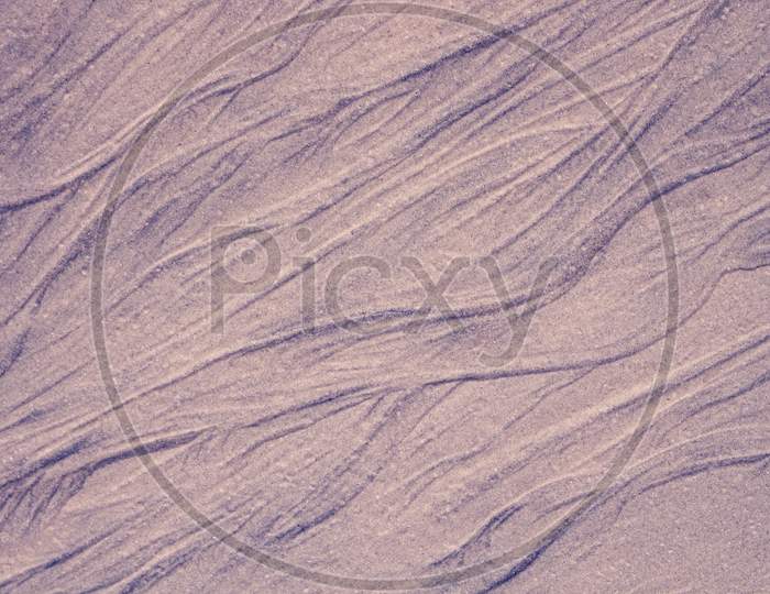Abstract Beach Pattern Formed By Sand And Water. Exotic Forms Of Sand.