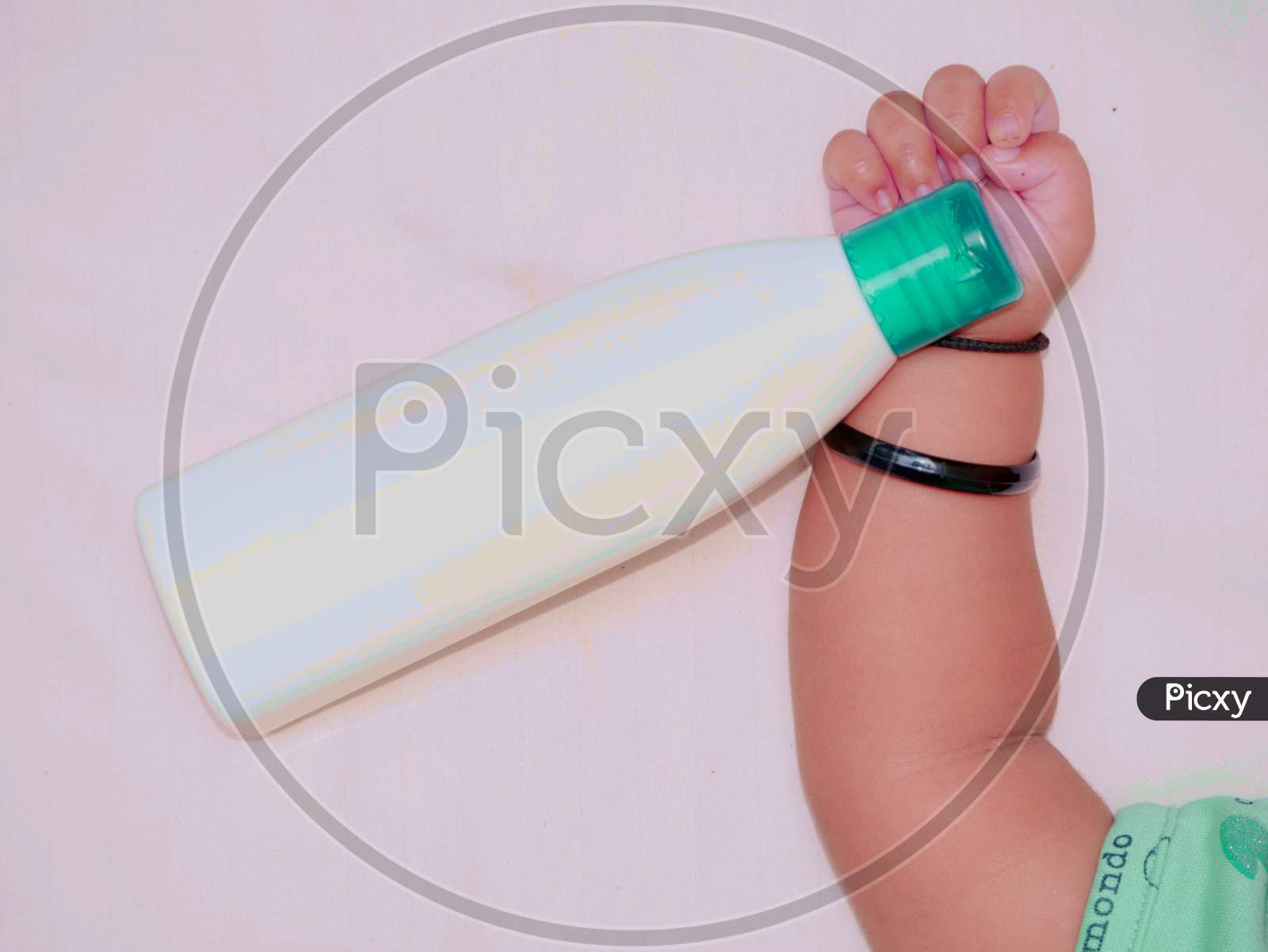 Image of Cute Baby Girl Hand Holding Skin Cosmetic Box For Kids Care  Lifestyle Concept.-GL488919-Picxy