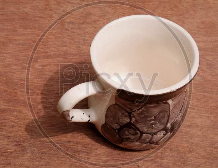 Empty Tea Cup Kept On Wooden Play Floor, Kitchen Cutlery Product Image.