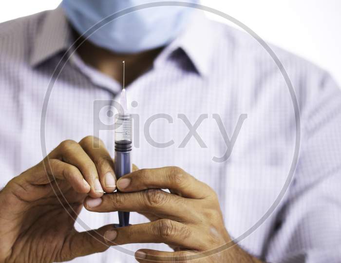 Doctor With Vaccine And Syringe