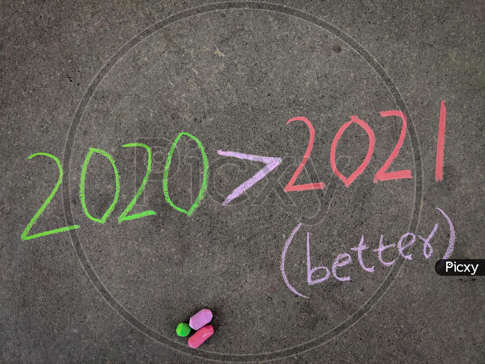 The Inscription Text On The Grey Board, 2020 Greater Than Symbol 2021 (2020 Better Than 2021) . Using Color Chalk Pieces.