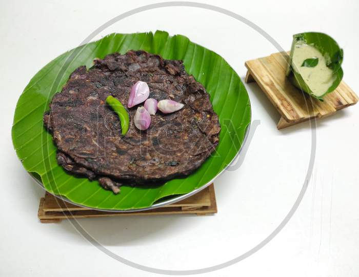 Closeup of Indian Traditional dish Ragi roti made with finger millet high protein content served with Chutney placed in a white isolated background.