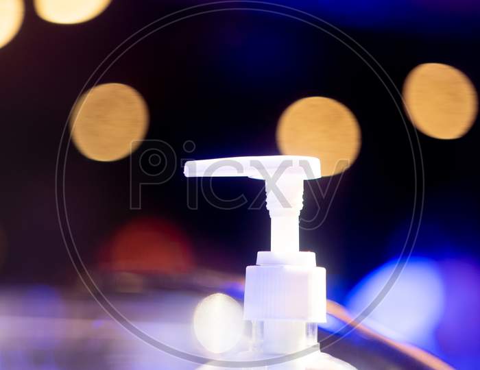 Sanitizer Bottle Nozzle With Out Of Focus Bokeh Balls Showing New Normal In Bars Clubs Restaurants Pubs Post The Coronavirus Covid 19 Pandemic As They Unlock