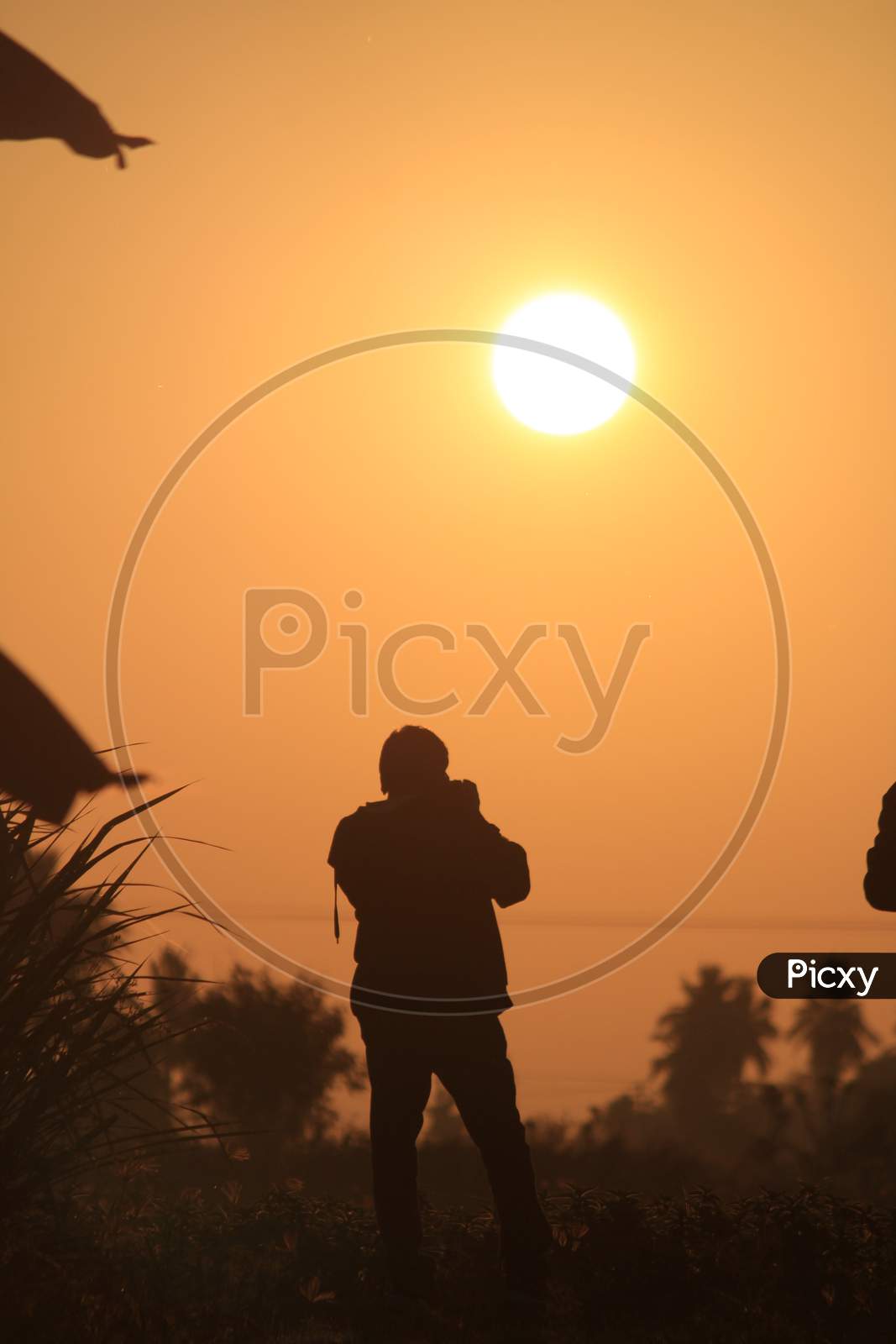 Silhouette Image Of Man Taking Photograph Of The Sunrise. Silhouette Picture Of Man In The Outdoor