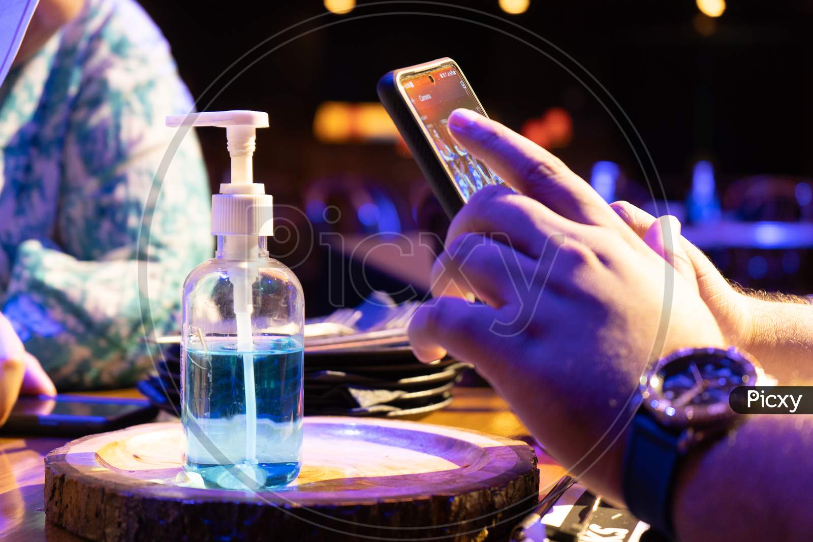 Image of Sanitizer Bottle With Qr Code For Digital Menu Being Scanned ...
