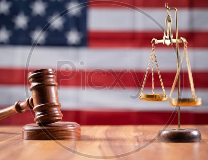 Concept Of Usa Or American Justice System Showing By Using Judge Gavel And Balance Scale On Us Flag As Background