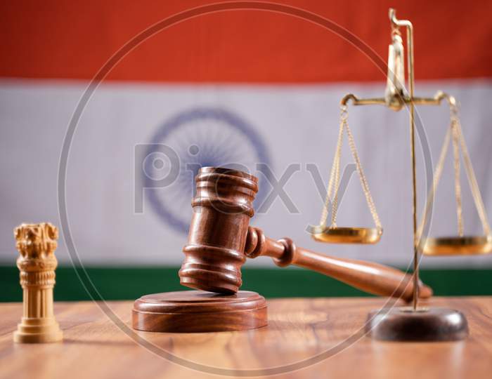 Concept Of Indian Justice System Showing By Using Judge Gavel, Balance Scale On Indian Flag As Background