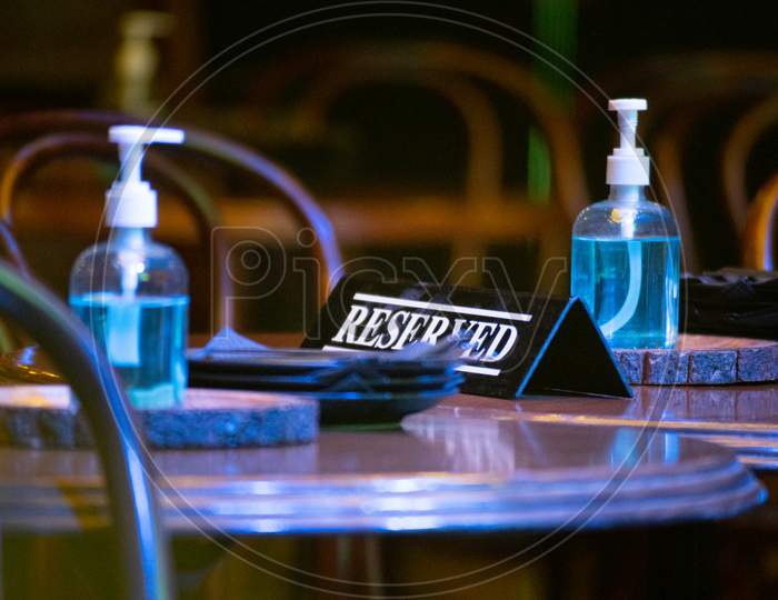 Reserved Sign On A Table With Sanitizers Placed Showing The New Normal And Opening Of Bars Clubs Pubs Restaurants Post The Coronavirus Covid19 Pandemic In India