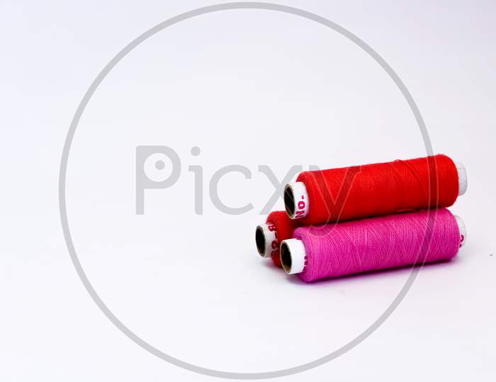 Colorful Spools Of Thread On White Background With Copy Space.