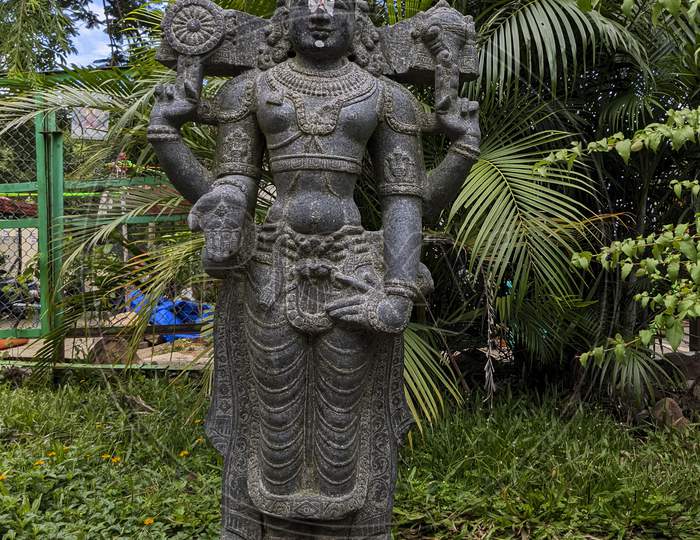 View Of Lord Sri Venkateshwara Stone idol isolated In Natural Rock Garden In Tirumala