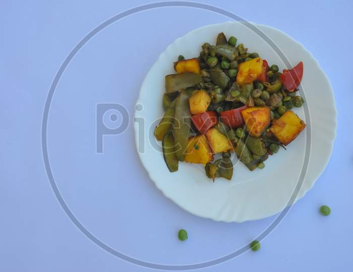 High angle view of matar paneer mix veg recipe (Indian food) over white background with copy space